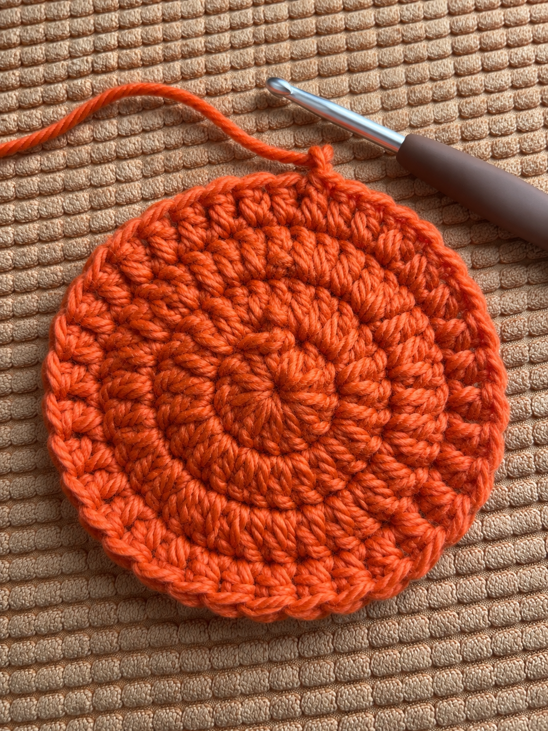 Near finished orange crochet pumpkin coaster 4