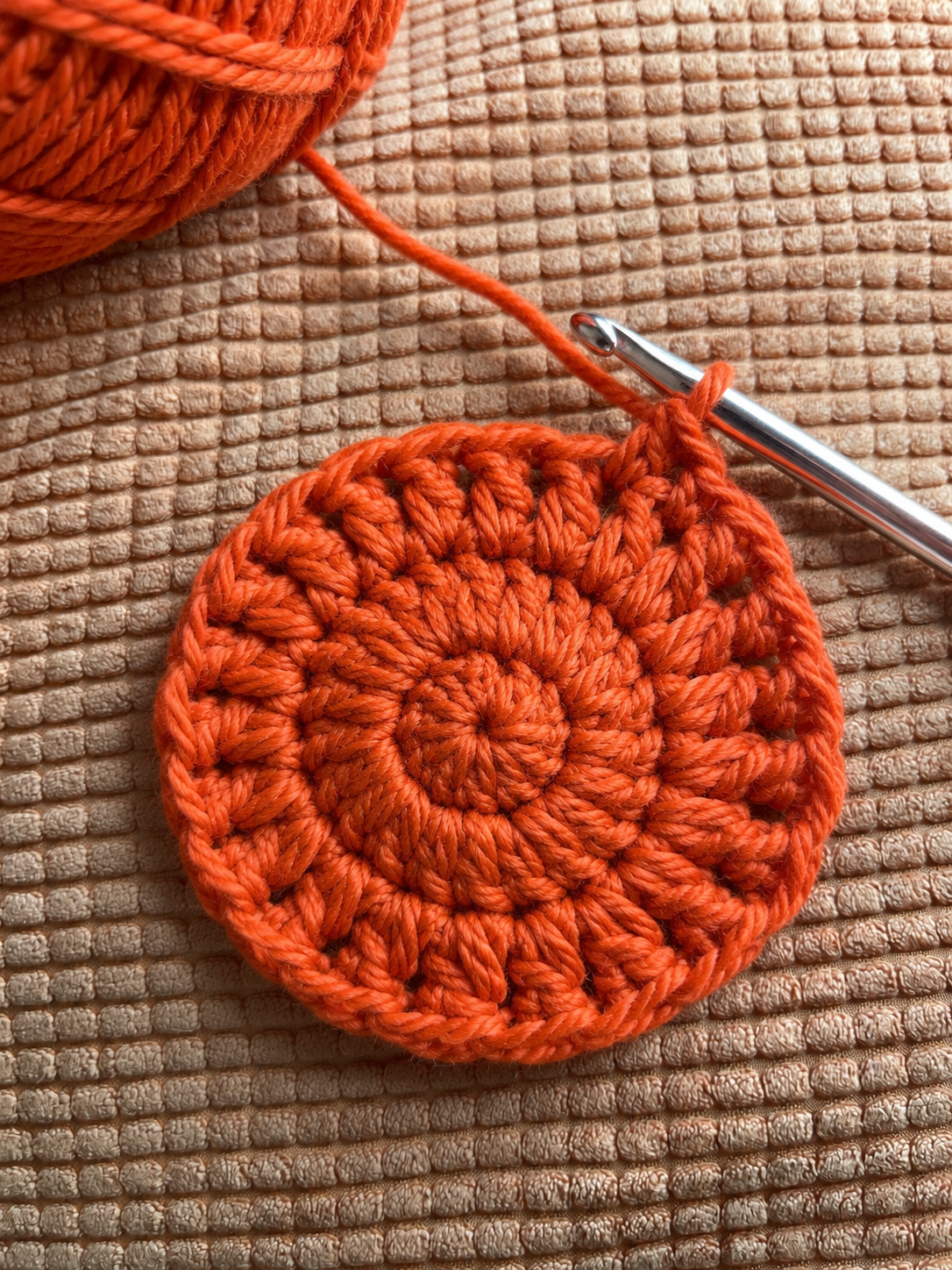 Step 3  Expanding burnt orange crochet circle 5